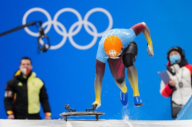 Christopher Grotheer, of Germany, starts the men's skeleton run 3 at the 2022 Winter Olympics, Friday, Feb. 11, 2022, in the Yanqing district of Beijing. (AP Photo/Mark Schiefelbein)
