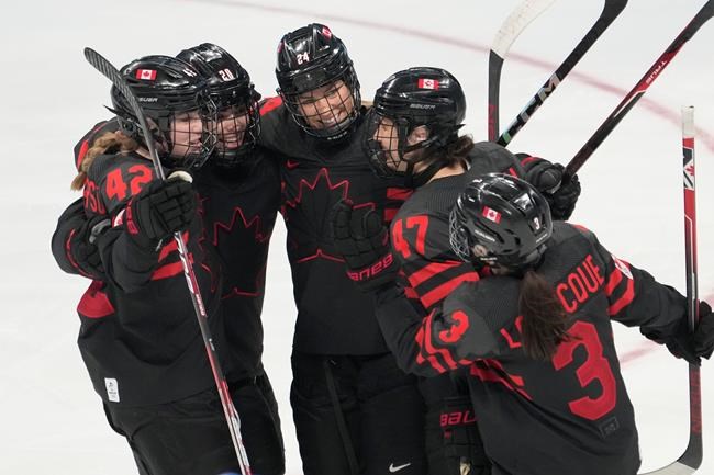 Team Canada players (left to right) Claire Thompson (42) Sarah Nurse (20), Natalie Spooner (24) Jamie Lee Rattray (47) and Jocelyne Larocque (3) celebrate a goal against Sweden during second period women's quarter-final round hockey action at the Beijing Winter Olympics in Beijing, China, on Friday, Feb. 11, 2022. THE CANADIAN PRESS/Ryan Remiorz