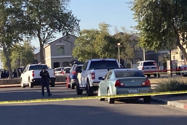 Shown is the scene near where five Phoenix police officers were shot and wounded after responding to a report of gunfire inside a home early Friday, Feb. 11, 2022, including four who were shot while trying to take a baby to safety, Police Chief Jeri Williams said. The status of the shooter and other details weren't immediately clear, but police later said a barricade situation at the home had been resolved. (AP Photo/Jacques Billed)