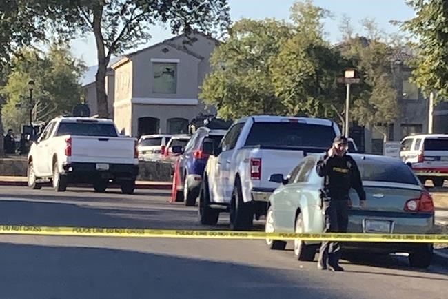 Shown is the scene near where five Phoenix police officers were shot and wounded after responding to a report of gunfire inside a home early Friday, Feb. 11, 2022, including four who were shot while trying to take a baby to safety, Police Chief Jeri Williams said.The status of the shooter and other details weren't immediately clear, but police later said a barricade situation at the home had been resolved. (AP Photo/Jacques Billed)