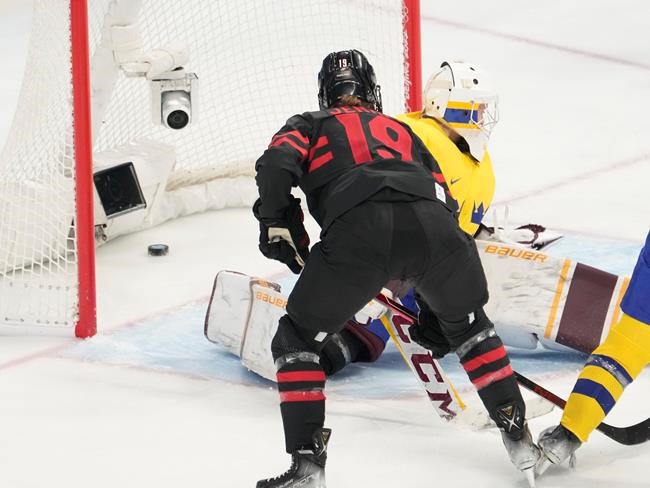 Team Canada forward Brianne Jenner (19) scores past Team Sweden goalkeeper Emma Soderberg (30) during first period women's quarter-final round hockey action at the Beijing Winter Olympics in Beijing, China, on Friday, Feb. 11, 2022. THE CANADIAN PRESS/Ryan Remiorz