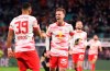 Leipzig's Dani Olmo, center, celebrates after scoring his side's second goal of the game during the German Bundesliga soccer match between RB Leipzig and 1. FC Cologne at the Red Bull Arena in Leipzig, Germany, Friday, Feb. 11, 2022. (Jan Woitas/dpa via AP)