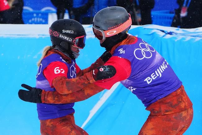 Canada's Meryeta O'Dine and Eliot Grondin celebrate their bronze medal in mixed team snowboard cross at the 2022 Beijing Winter Olympics in Zhangjiakou, China on Saturday, Feb. 12, 2022. THE CANADIAN PRESS/Sean Kilpatrick