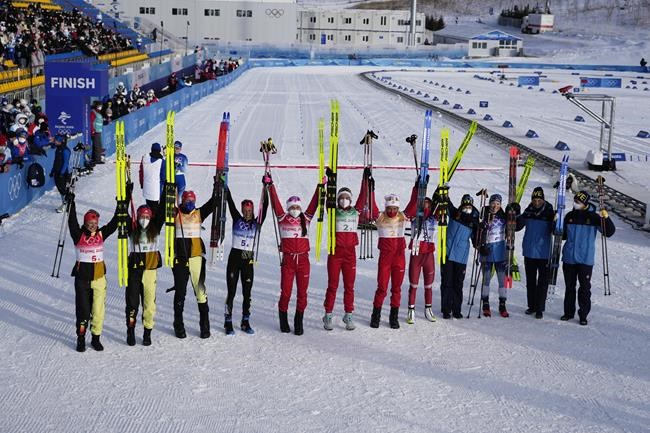 From left, Silver medal finishers Germany, gold medal finishers Russian Olympic Committee, and bronze medal finishers Sweden pose after the women's 4 x 5km relay cross-country skiing competition at the 2022 Winter Olympics, Saturday, Feb. 12, 2022, in Zhangjiakou, China. (AP Photo/Alessandra Tarantino)