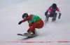 Canada's Meryeta O'Dine crosses the finish line ahead of United States' Faye Gulini during their leg of the mixed team snowboard cross at the 2022 Beijing Winter Olympics in Zhangjiakou, China, Saturday, Feb. 12, 2022. THE CANADIAN PRESS/Sean Kilpatrick