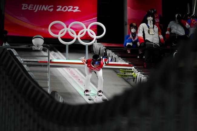Casey Larson, of the United States, speeds down the hill during a men's large hill individual trial round for competition at the 2022 Winter Olympics, Saturday, Feb. 12, 2022, in Zhangjiakou, China. (AP Photo/Andrew Medichini)