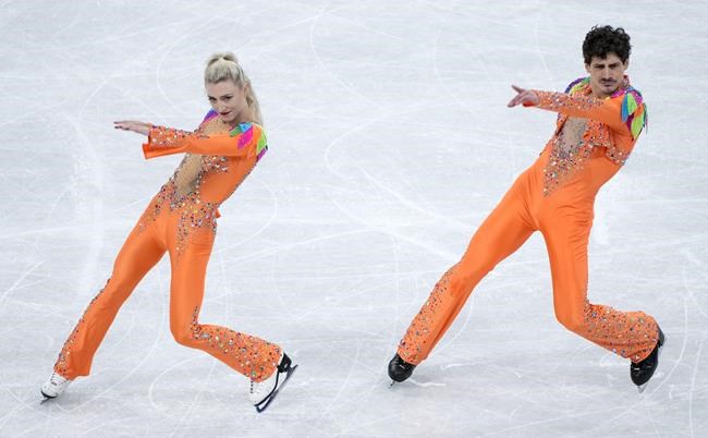 Piper Gilles and Paul Poirier of Canada perform their rhythm dance at the Olympic Winter Games in Beijing, Saturday, Feb. 12, 2022. THE CANADIAN PRESS/Paul Chiasson