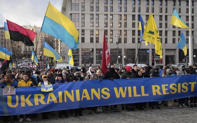 Ukrainians attend a rally in central Kyiv, Ukraine, Saturday, Feb. 12, 2022, during a protest against the potential escalation of the tension between Russia and Ukraine. Russian President Vladimir Putin and U.S. President Joe Biden are to hold a high-stakes telephone call on Saturday as tensions over a possibility imminent invasion of Ukraine escalated sharply and the U.S. announced plans to evacuate its embassy in the Ukrainian capital. (AP Photo/Efrem Lukatsky)
