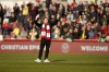 Brentford's Christian Eriksen gestures as he walks in the field ahead of the English Premier League soccer match between Brentford and Crystal Palace at Brentford Community stadium in London, Saturday, Feb. 12, 2022. (AP Photo/David Cliff)