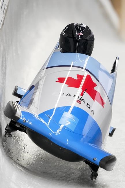 Christine De Bruin, of Canada, drives during the women's monobob heat 1 at the 2022 Winter Olympics, Sunday, Feb. 13, 2022, in the Yanqing district of Beijing. (AP Photo/Dmitri Lovetsky)