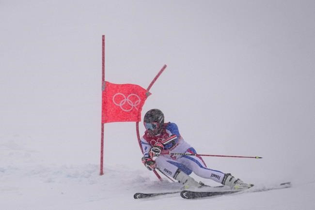 Mathieu Faivre, of France passes a gate during the first run of the men's giant slalom at the 2022 Winter Olympics, Sunday, Feb. 13, 2022, in the Yanqing district of Beijing. (AP Photo/Robert F. Bukaty)