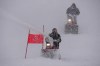 Course workers blow snow from the men's giant slalom course as the snow comes down at the alpine ski venue at the 2022 Winter Olympics, Sunday, Feb. 13, 2022, in the Yanqing district of Beijing. (AP Photo/Robert F. Bukaty)
