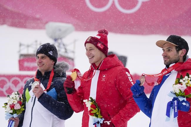 From left, Zan Kranjec, of Slovenia, Marco Odermatt, of Switzerland, and Mathieu Faivre, of France, pose with their medals at the podium for the men's giant slalom at the 2022 Winter Olympics, Sunday, Feb. 13, 2022, in the Yanqing district of Beijing. (AP Photo/Luca Bruno)