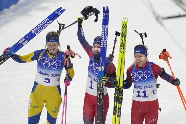 From left Elvira Oeberg of Sweden (2), Marte Olsbu Roeiseland of Norway (1) and Tiril Eckhoff of Norway stand after the women's 10-kilometer pursuit race at the 2022 Winter Olympics, Sunday, Feb. 13, 2022, in Zhangjiakou, China. (AP Photo/Kirsty Wigglesworth)