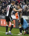 Newcastle United's Kieran Trippier, right, celebrates with teammate Dan Burn, after scoring his side's first goal of the game from a free-kick, during the English Premier League soccer match between Newcastle United and Aston Villa, at St. James' Park, in Newcastle, England, Sunday, Feb. 13, 2022. (Owen Humphreys/PA via AP)
