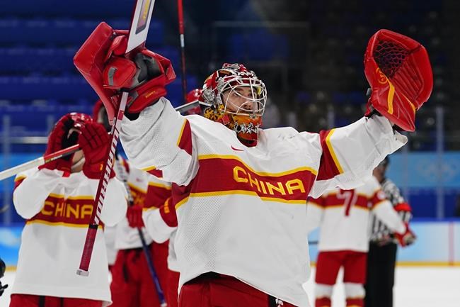 China goalkeeper Jieruimi Shimisi (Jeremy Smith) waves to fans as the team leaves the ice after a preliminary round men's hockey game against Germany at the 2022 Winter Olympics, Saturday, Feb. 12, 2022, in Beijing. (AP Photo/Matt Slocum)