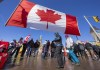 People gather for an anti-mandate protest on Parliament Hill in Ottawa on Sunday, February 13, 2022.&nbsp;Ottawa's mayor has set a deadline of noon today for truckers encamped in the capital's core to move out of residential streets in a bid to pare down the size of the protest's footprint. THE CANADIAN PRESS/Frank Gunn