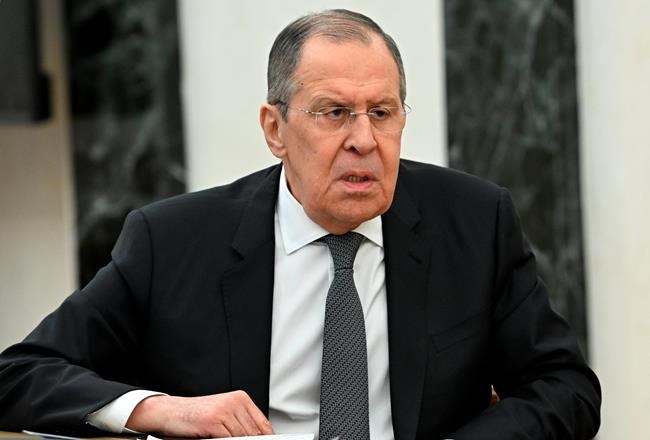 Russian Foreign Minister Sergey Lavrov speaks to Russian President Vladimir Putin during their meeting in Moscow, Russia, Monday, Feb. 14, 2022. Russia's top diplomat has advised President Vladimir Putin to continue talks with the West on Russian security demands amid tensions over Ukraine. Speaking at the start of a meeting with Putin, Foreign Minister Sergey Lavrov suggested Russia should continue a dialogue with the U.S. and its allies even though they have rejected Moscow's main security demands. (Alexei Nikolsky, Sputnik, Kremlin Pool Photo via AP)