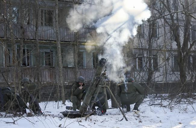 The National Guard soldiers take part in tactical exercises, which are conducted by the Ukrainian National Guard, Armed Forces, special operations units and simulate a crisis situation in an urban settlement, in the abandoned city of Pripyat near the Chernobyl Nuclear Power Plant, Ukraine, Friday, Feb. 4, 2022. Prime Minister Justin Trudeau says Canada will provide a $500-million loan and $7.8 million worth of lethal equipment and ammunition to Ukraine as the threat of a Russian invasion grows.THE CANADIAN PRESS/AP-Mykola Tymchenko