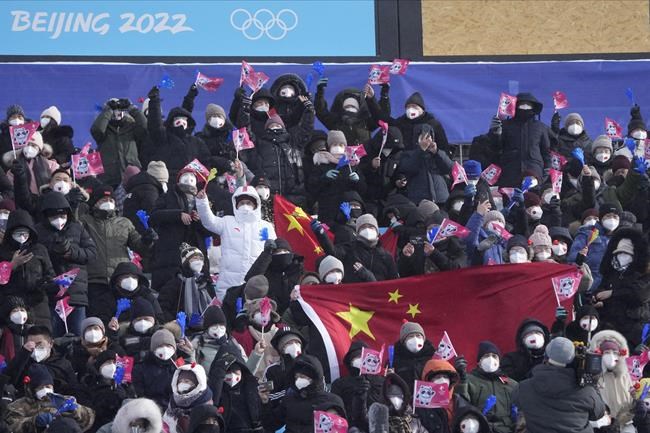 Spectators cheer as they wait for the women's slopestyle finals at the 2022 Winter Olympics, Tuesday, Feb. 15, 2022, in Zhangjiakou, China. (AP Photo/Lee Jin-man)
