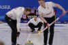 Canada's Brad Gushue throws a rock during a men's curling match against the United States at the Beijing Winter Olympics, in Beijing, Sunday, Feb. 13, 2022. Gushue hit a tap against two with the final rock of the 10th end, and Canada's men's curling team picked up a nervy 10-8 win over China on Tuesday at the Beijing Olympics. THE CANADIAN PRESS/AP-Brynn Anderson