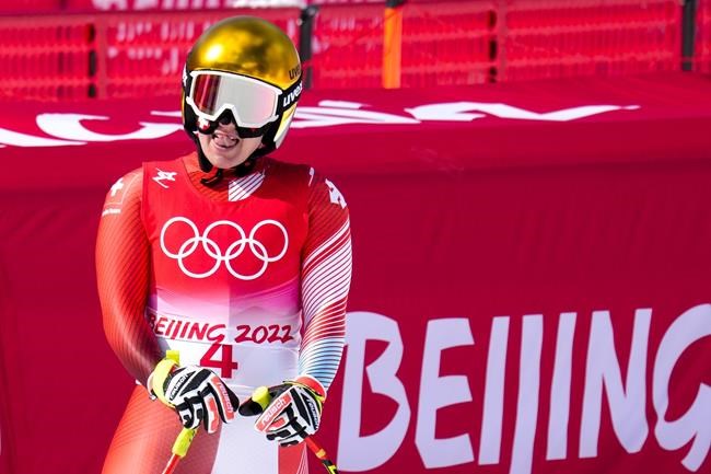 Joana Haehlen, of Switzerland, gestures after women's downhill at the 2022 Winter Olympics, Tuesday, Feb. 15, 2022, in the Yanqing district of Beijing. (AP Photo/Luca Bruno)