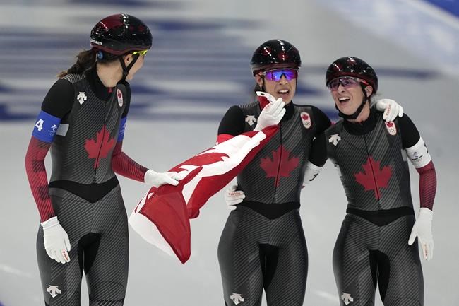 Team Canada, with Isabelle Weidemann left, Valerie Maltais center and Ivanie Blondin, react after wining the gold medal and setting an Olympic record in the speedskating women's team pursuit finals at the 2022 Winter Olympics, Tuesday, Feb. 15, 2022, in Beijing. THE CANADIAN PRESS/AP/Ashley Landis
