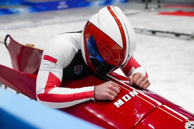 Rudy Rinaldi, of Monaco, looks down after the 2-man heat 4 at the 2022 Winter Olympics, Tuesday, Feb. 15, 2022, in the Yanqing district of Beijing. (AP Photo/Dmitri Lovetsky)