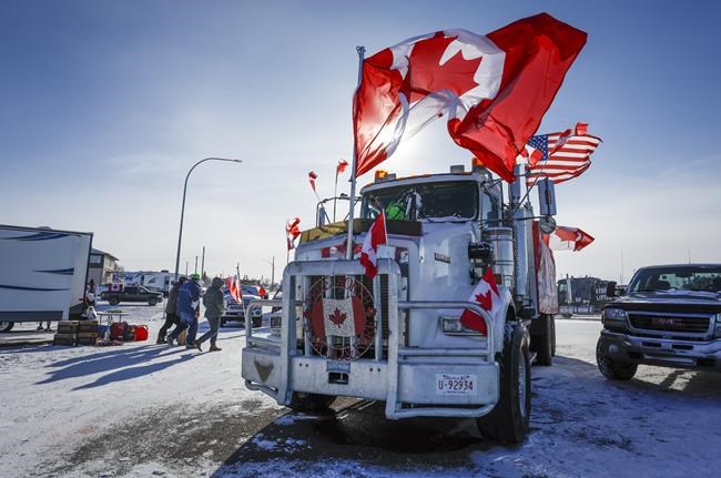 The last truck blocking the southbound lane moves after a breakthrough to resolve the impasse at a protest blockade at the United States border in Coutts, Alta., Wednesday, Feb. 2, 2022. THE CANADIAN PRESS/Jeff McIntosh