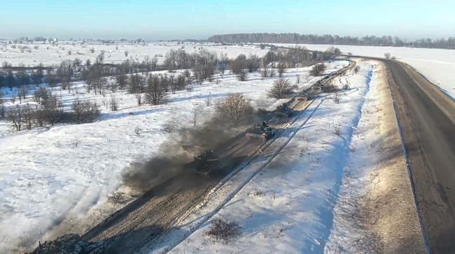 In this photo taken from video provided by the Russian Defense Ministry Press Service on Tuesday, Feb. 15, 2022, Russian army tanks move back to their permanent base after drills in Russia. In what could be another sign that the Kremlin would like to lower the temperature, Russia's Defense Ministry announced Tuesday that some units participating in military exercises would begin returning to their bases. (Russian Defense Ministry Press Service via AP)