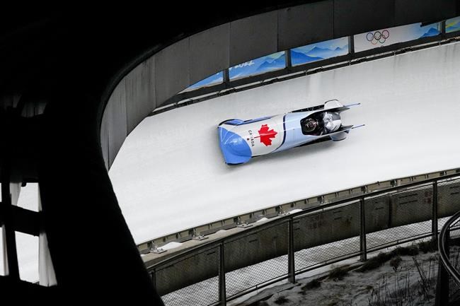 Justin Kripps and Cam Stones of Canada, slide during the 2-man heat 3 at the 2022 Winter Olympics, Tuesday, Feb. 15, 2022, in the Yanqing district of Beijing. THE CANADIAN PRESS/AP-Pavel Golovkin