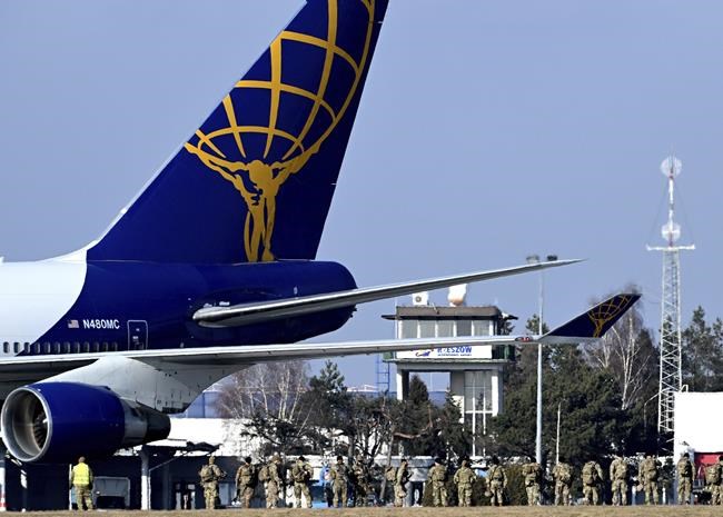 U.S. Army troops of the 82nd Airborne Division just after arrival at the Rzeszow-Jasionka airport in southeastern Poland, on Tuesday, Feb. 15, 2022. Additional U.S. troops are arriving in Poland after President Joe Biden ordered the deployment of 1,700 and then another 3,000 soldiers here amid fears of a Russian invasion of Ukraine. Some 4,000 U.S. troops have been stationed in Poland since 2017. (AP Photo)