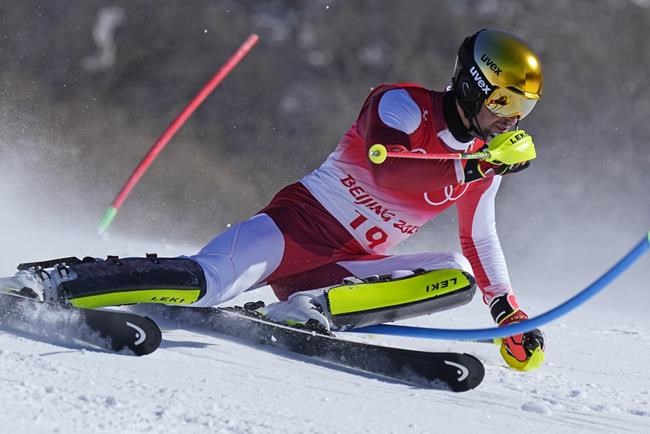 Johannes Strolz, of Austria passes a gate during the first run of the men's slalom at the 2022 Winter Olympics, Wednesday, Feb. 16, 2022, in the Yanqing district of Beijing. (AP Photo/Robert F. Bukaty)