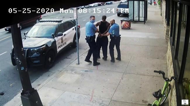FILE - This image from video shows Minneapolis Police Officers Thomas Lane, left and J. Alexander Kueng, right, escorting George Floyd, center, to a police vehicle outside Cup Foods in Minneapolis, on May 25, 2020. The two and another former Minneapolis officers are on trial in February 2022, on federal civil rights charges in Floyd's death. All three are expected to testify. (Court TV via AP, Pool, File)
