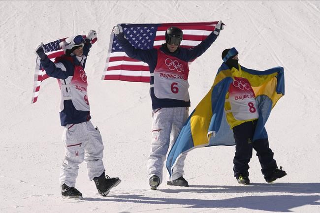 From left silver medal winner United State's Nick Goepper, gold medal winner United States' Alexander Hall and bronze medal winner Sweden's Jesper Tjader celebrate afrter the men's slopestyle finals at the 2022 Winter Olympics, Wednesday, Feb. 16, 2022, in Zhangjiakou, China. (AP Photo/Francisco Seco)