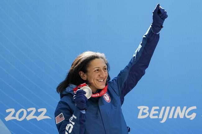 Elana Meyers Taylor, of the United States, celebrates winning the silver medal in the women's monobob at the 2022 Winter Olympics, Monday, Feb. 14, 2022, in the Yanqing district of Beijing. (AP Photo/Pavel Golovkin)