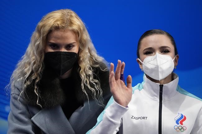 Coach Eteri Tutberidze, left, sits with Kamila Valieva, of the Russian Olympic Committee, after the women's short program during the figure skating at the 2022 Winter Olympics, Tuesday, Feb. 15, 2022, in Beijing. (AP Photo/Natacha Pisarenko)
