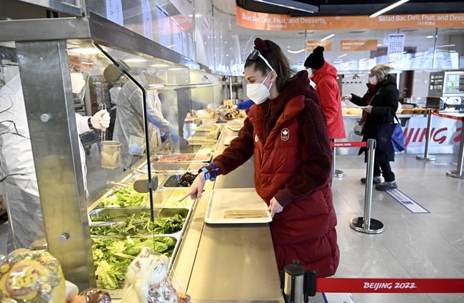 FILE - An athlete orders food at a restaurant at the Olympic Village ahead of the 2022 Winter Olympics, Feb. 1, 2022, in Beijing. (Wang Zhao/Pool Photo via AP, File)