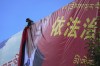 A man unfurls a banner reading 