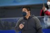 Ryan Shimabukuro, a coach for the United States speedskating team, works during the men's speedskating 1,500-meter race at the 2022 Winter Olympics, Tuesday, Feb. 8, 2022, in Beijing. (AP Photo/Ashley Landis)