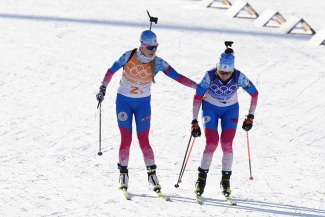 Svetlana Mironova of the Russian Olympic Committee, left, tags teammate Uliana Nigmatullina during the women's 4x6-kilometer relay at the 2022 Winter Olympics, Wednesday, Feb. 16, 2022, in Zhangjiakou, China. (AP Photo/Kirsty Wigglesworth)