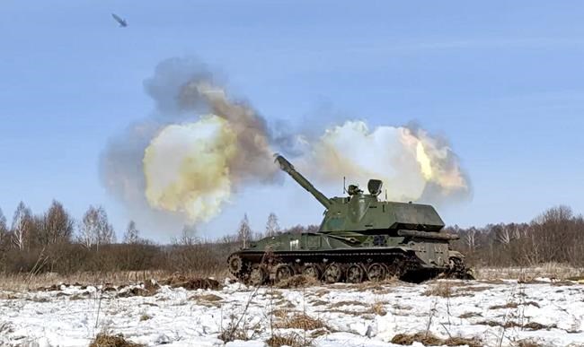 In this photo taken from video provided by the Russian Defense Ministry Press Service on Tuesday, Feb. 15, 2022, a self-propelled artillery mount fires at the Osipovichi training ground during the Union Courage-2022 Russia-Belarus military drills in Belarus. (Russian Defense Ministry Press Service via AP)