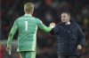 Leicester's manager Brendan Rodgers, right, shakes hand with his player goalkeeper Kasper Schmeichel at the end of the English Premier League soccer match between Liverpool and Leicester City at Anfield stadium in Liverpool, England, Thursday, Feb. 10, 2022. Liverpool won 2-0. (AP Photo/Jon Super)