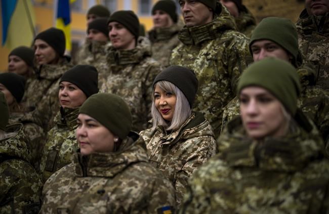 Ukrainian Army soldiers pose for a photo as they gather to celebrate a Day of Unity in Odessa, Ukraine, Wednesday, Feb. 16, 2022. As Western officials warned a Russian invasion could happen as early as today, the Ukrainian President Zelenskyy called for a Day of Unity, with Ukrainians encouraged to raise Ukrainian flags across the country. (AP Photo/Emilio Morenatti)