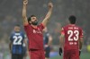 Liverpool's Mohamed Salah celebrates after scoring his side's second goal during the Champions League, round of 16, first leg soccer match between Inter Milan and Liverpool at the San Siro stadium in Milan, Italy, Wednesday, Feb. 16, 2022. (AP Photo/Antonio Calanni)