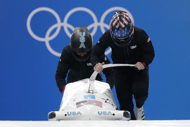 Kaillie Humphries of the United States starts a run during a 2-woman bobsled training at the 2022 Winter Olympics, Wednesday, Feb. 16, 2022, in the Yanqing district of Beijing. (AP Photo/Mark Schiefelbein)