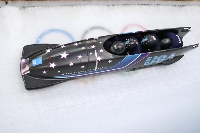 Frank Delduca of the United States and his team drive their 4-man bobsled during a training heat at the 2022 Winter Olympics, Wednesday, Feb. 16, 2022, in the Yanqing district of Beijing. (AP Photo/Dmitri Lovetsky)