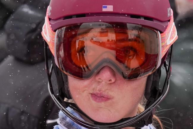 Mikaela Shiffrin, of the United States, gestures after falling in the women's combine slalom at the 2022 Winter Olympics, Thursday, Feb. 17, 2022, in the Yanqing district of Beijing. (AP Photo/Luca Bruno)