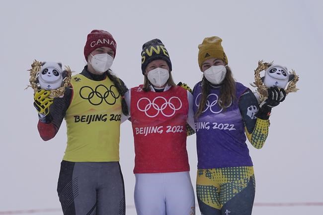 From left silver medal winner Canada's Marielle Thompson, gold medal winner Sweden's Sandra Naeslund and bronze medal winner Germany's Daniela Maier celebrate during the venue award ceremony for the women's cross at the 2022 Winter Olympics, Thursday, Feb. 17, 2022, in Zhangjiakou, China. (AP Photo/Gregory Bull)