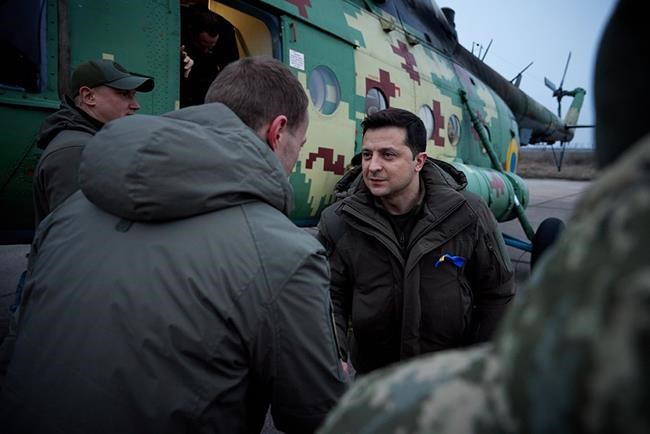 In this handout photo provided by the Ukrainian Presidential Press Office, Ukrainian President Volodymyr Zelenskyy greets Ukrainian coast guards in Mariupol, Donetsk region, eastern Ukraine, Thursday, Feb. 17, 2022. U.S. Secretary of State Antony Blinken told ABC News that Russian President Vladimir Putin